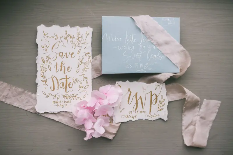 Stylish wedding invitation set with calligraphy, featuring RSVP and floral elements