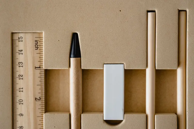 Top view of neatly organized school supplies, including ruler, pencil, and eraser