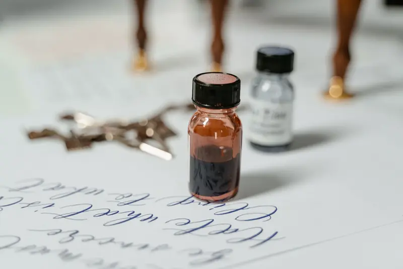 Elegant close-up of ink bottles with calligraphy script on paper, ideal for creative themes
